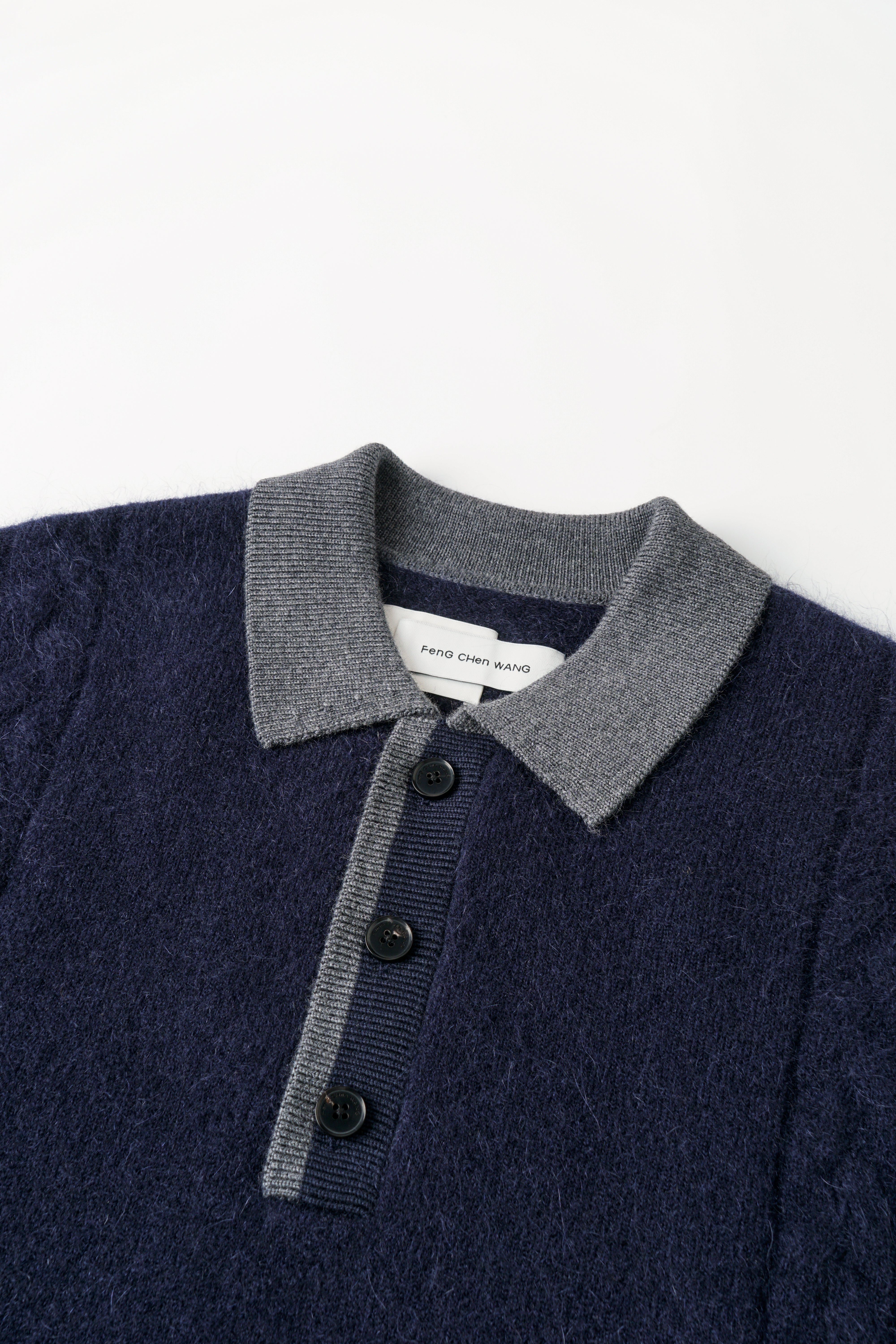 CABLE-KNIT POLO SHIRT WITH RAW HEM AND PATCHWORK