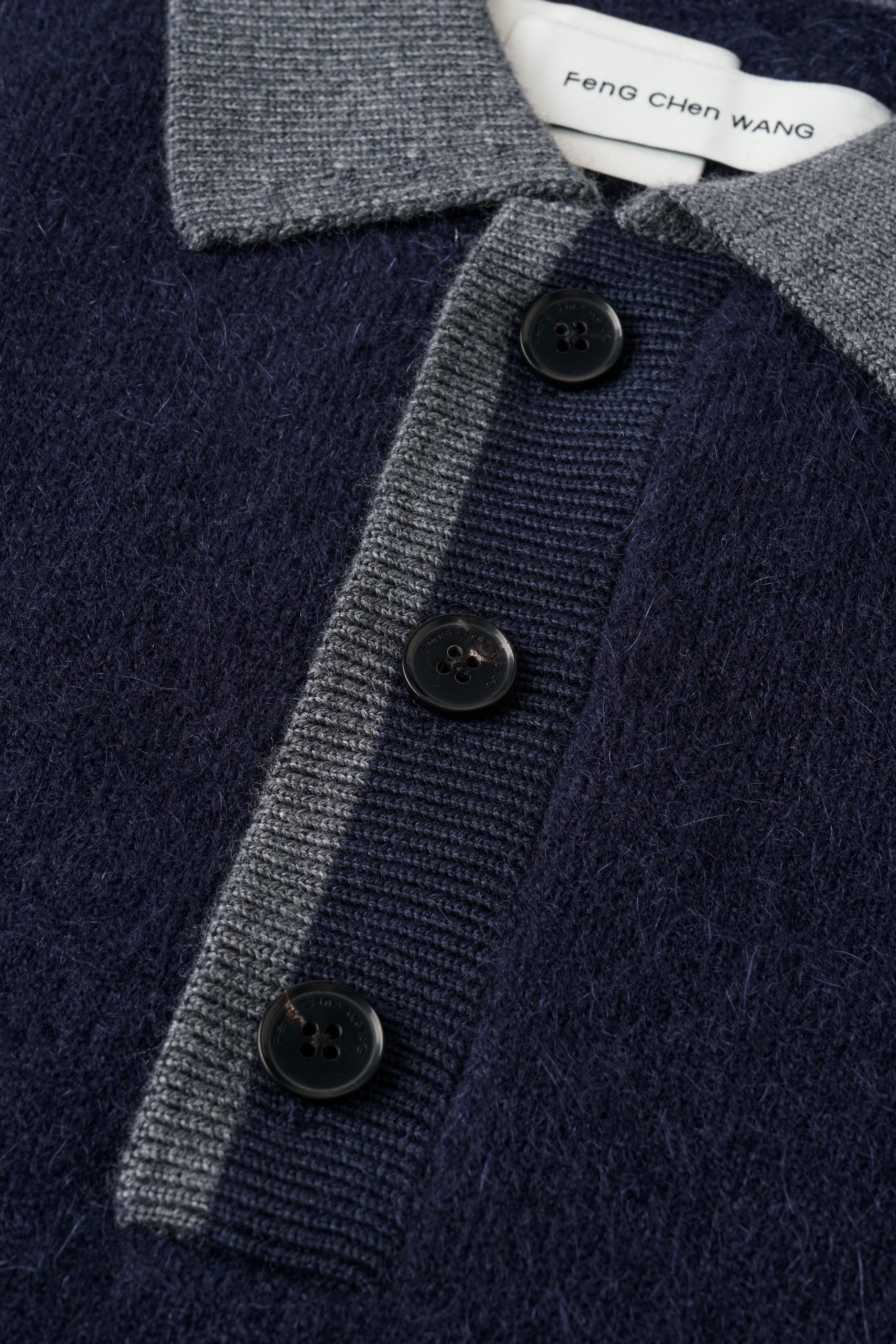 CABLE-KNIT POLO SHIRT WITH RAW HEM AND PATCHWORK