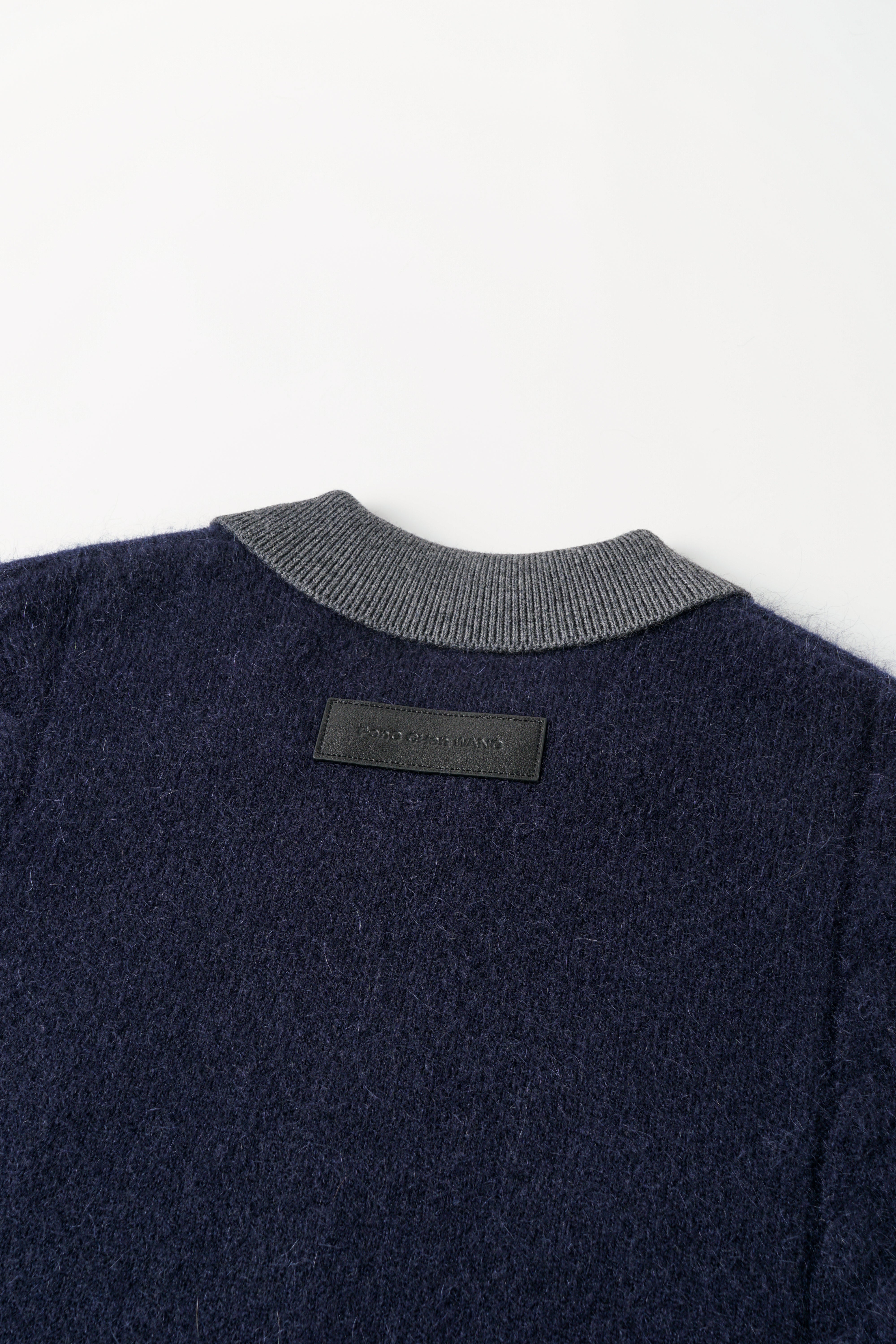CABLE-KNIT POLO SHIRT WITH RAW HEM AND PATCHWORK